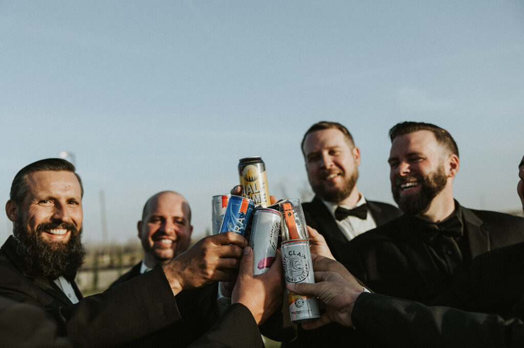 Groom and groomsmen toasting drinks