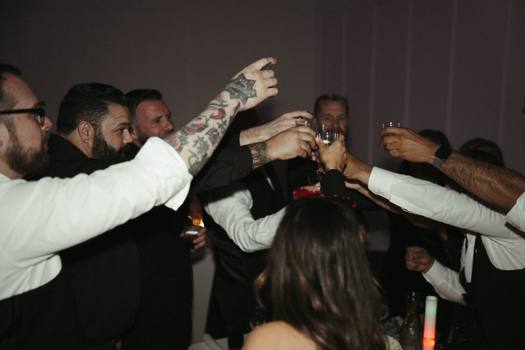 Groomsmen toasting during reception