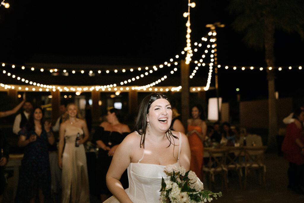 Bride tossing wedding bouquet