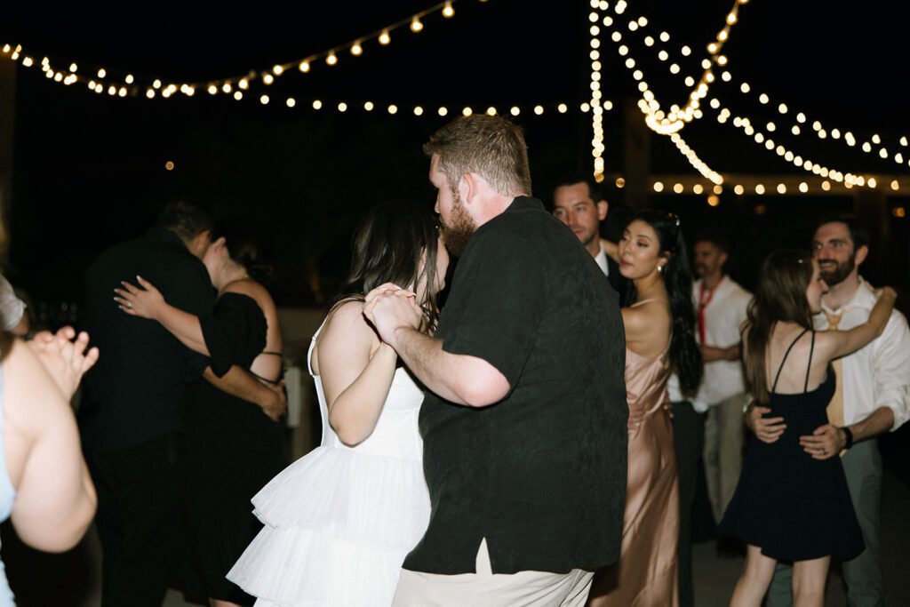 Bride and groom dancing at the end of their wedding reception