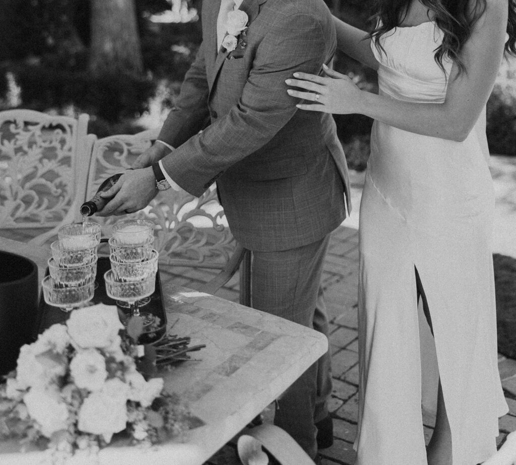 Bride and groom pouring champagne 