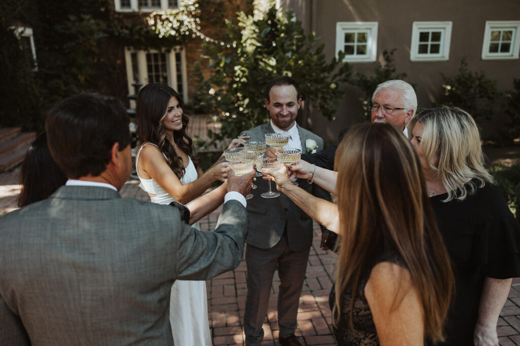 Bride and groom toasting with guests and champagne 