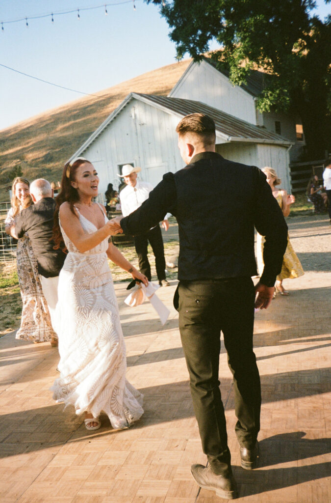 Bride and groom dancing on film