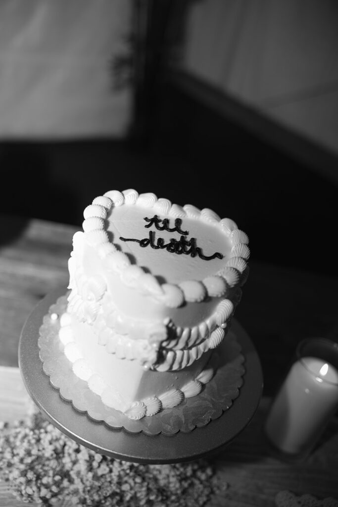 Vintage wedding cake that says "till death"