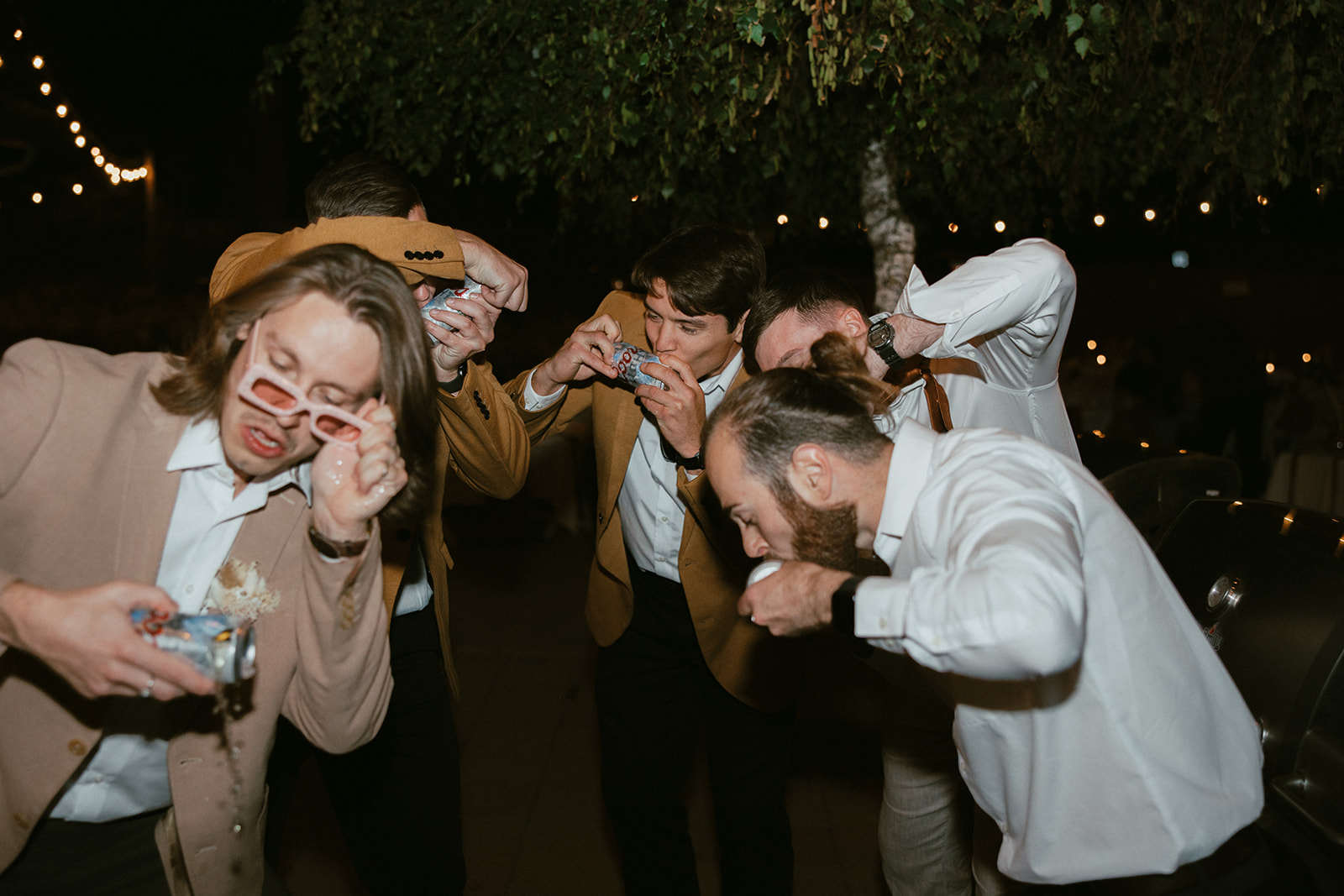 Guests chugging beers during wedding reception