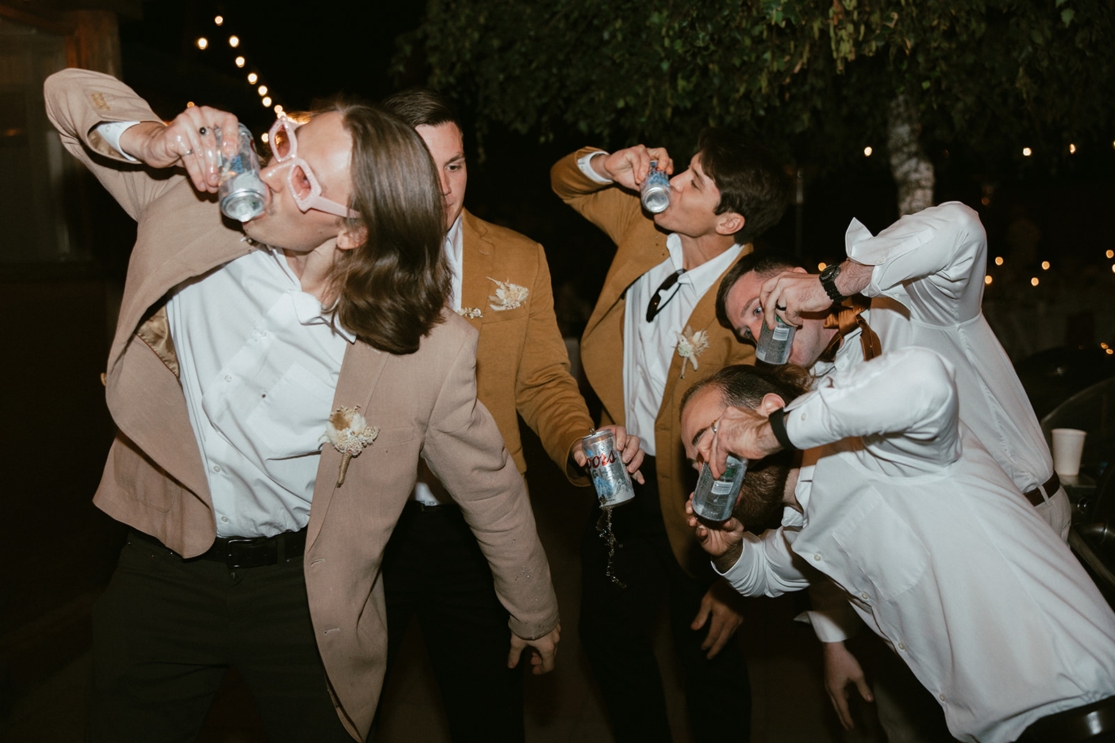 Guests chugging beers during wedding reception