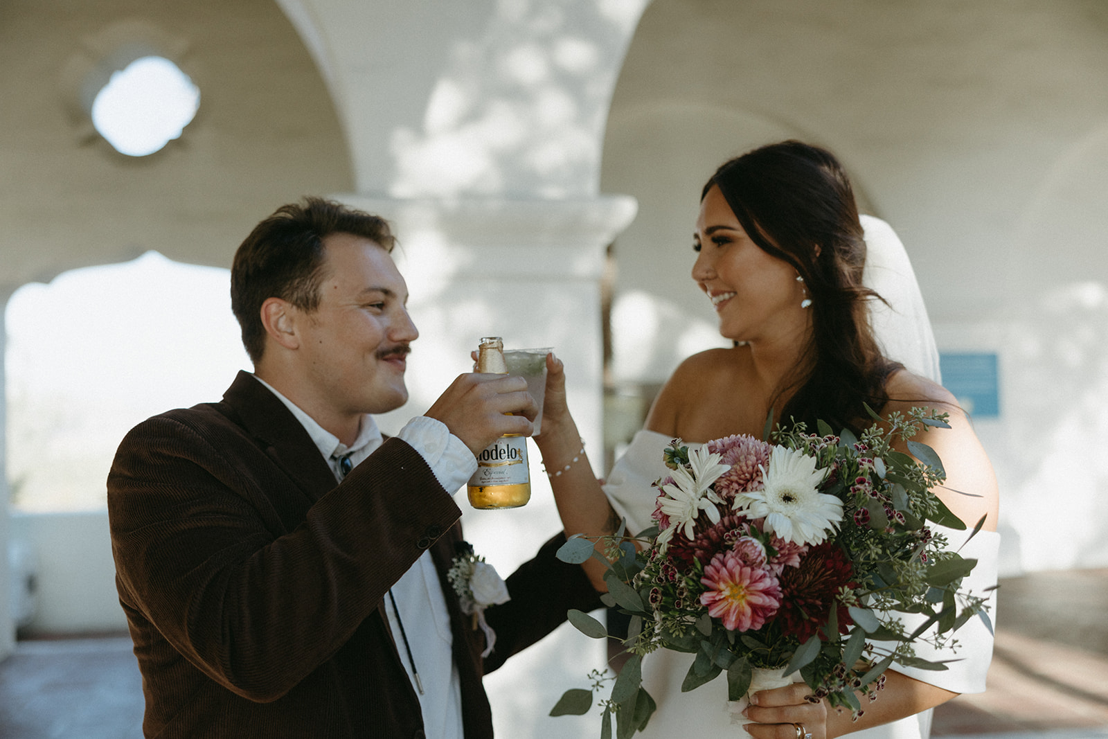 Bride and groom toasting drinks