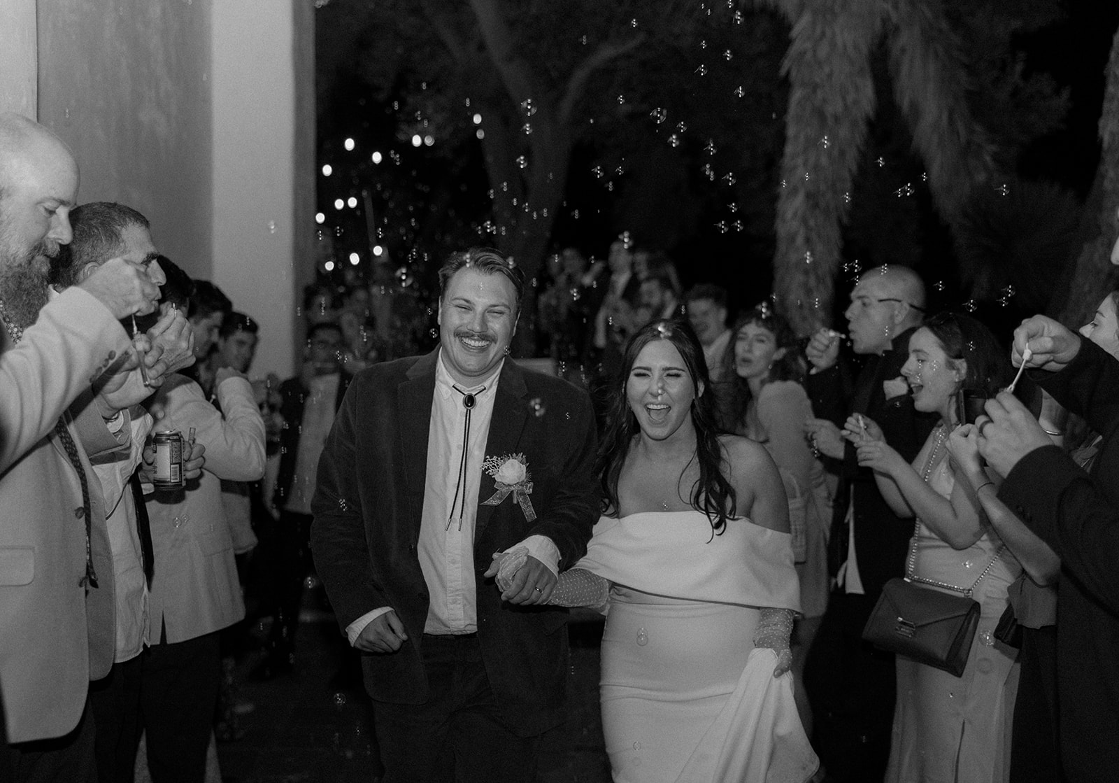 Bride and grooms bubble exit from a San Diego wedding at The Junipero Serra Museum